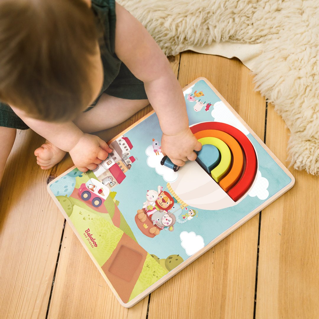 Drive Through the Rainbow Puzzle Game lifestyle image with child top down